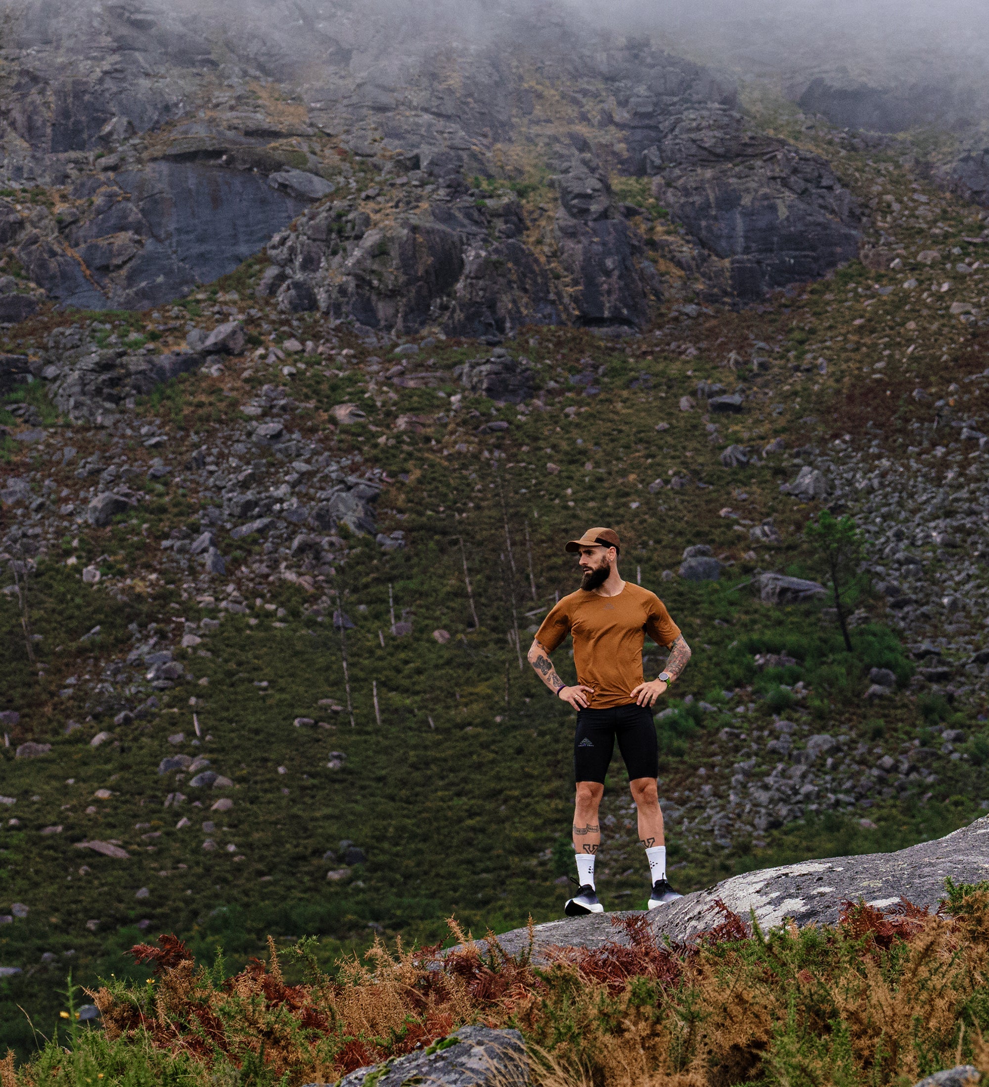 Man standing on rock on mountainside