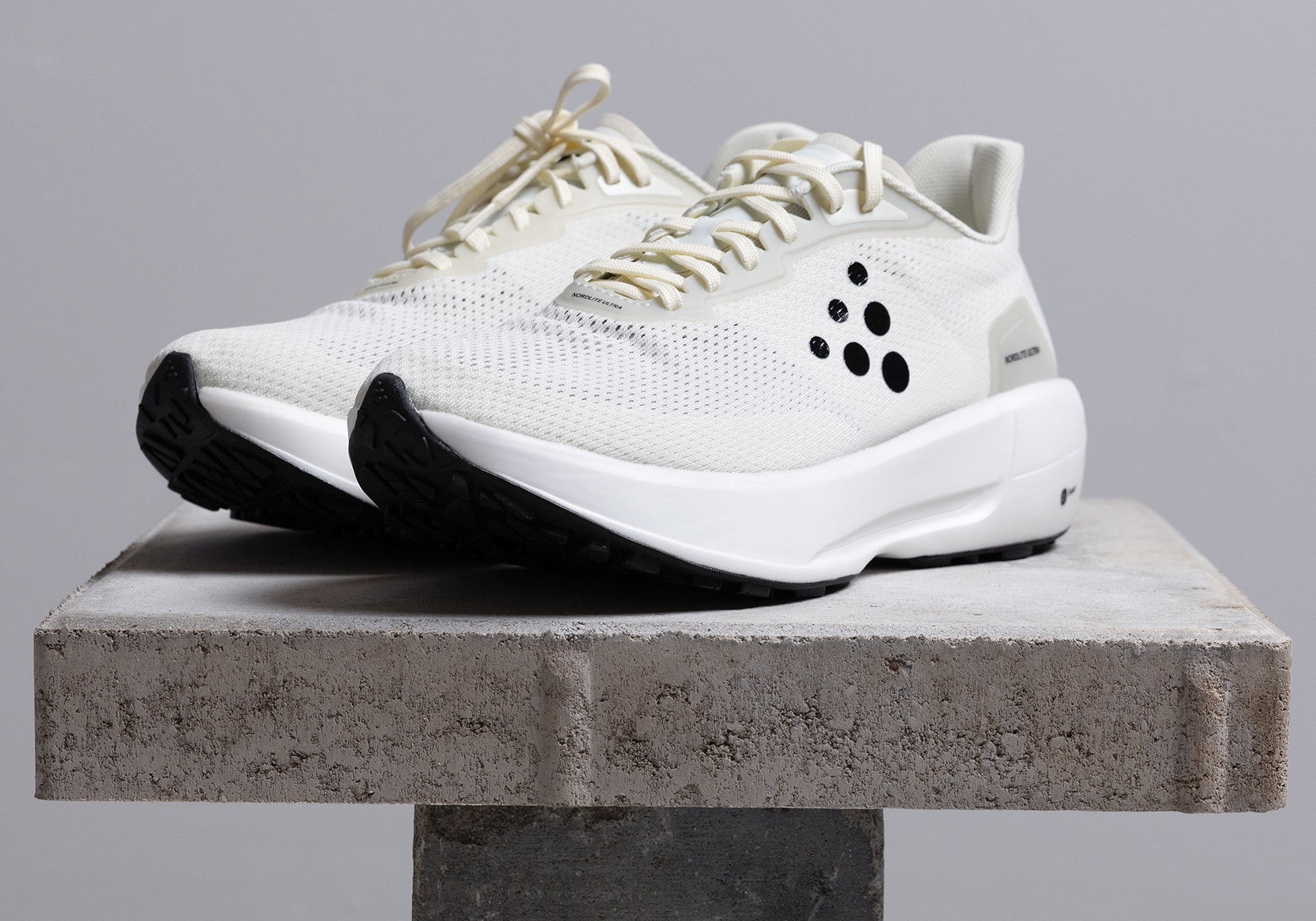 White running shoes on table