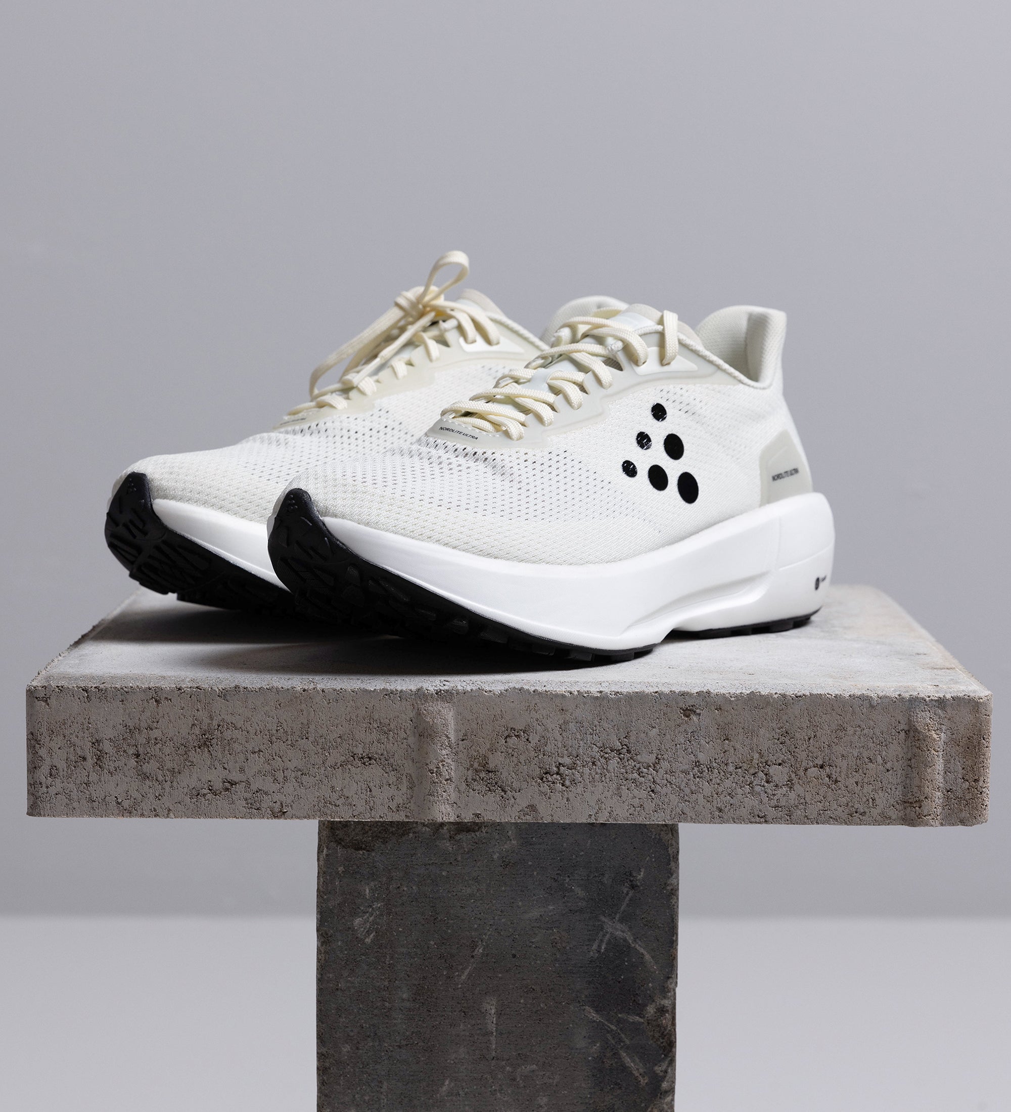 White running shoes on table