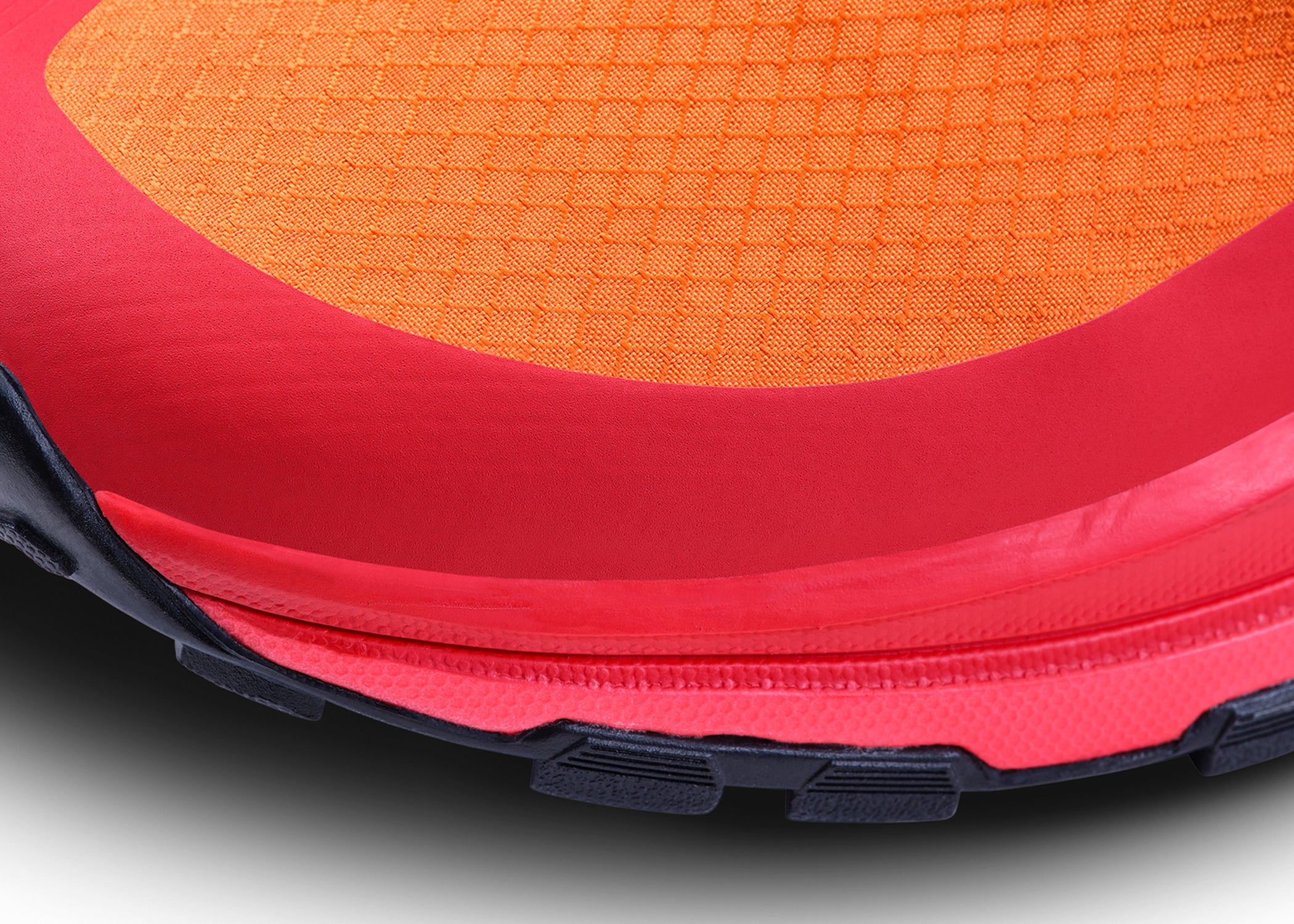 Side toe detail of bright colored running shoe.