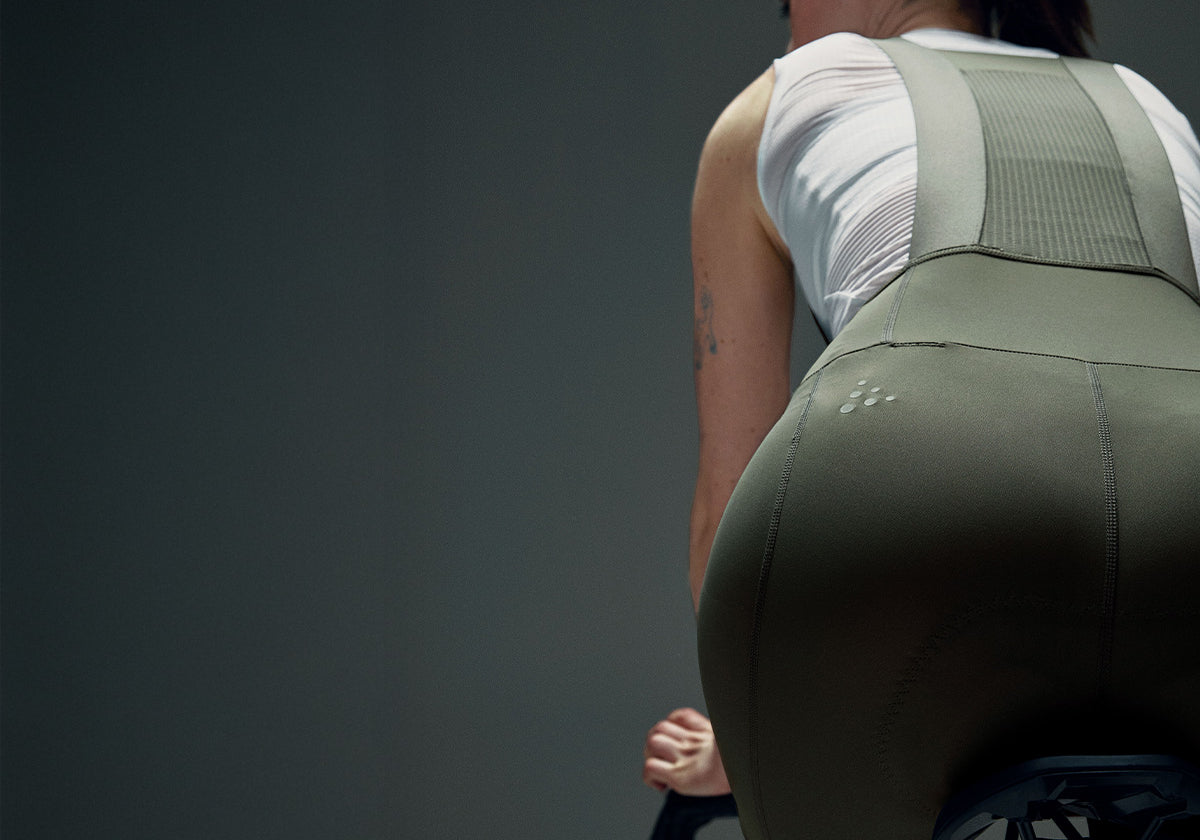 Person wearing a green athletic outfit against a gray background