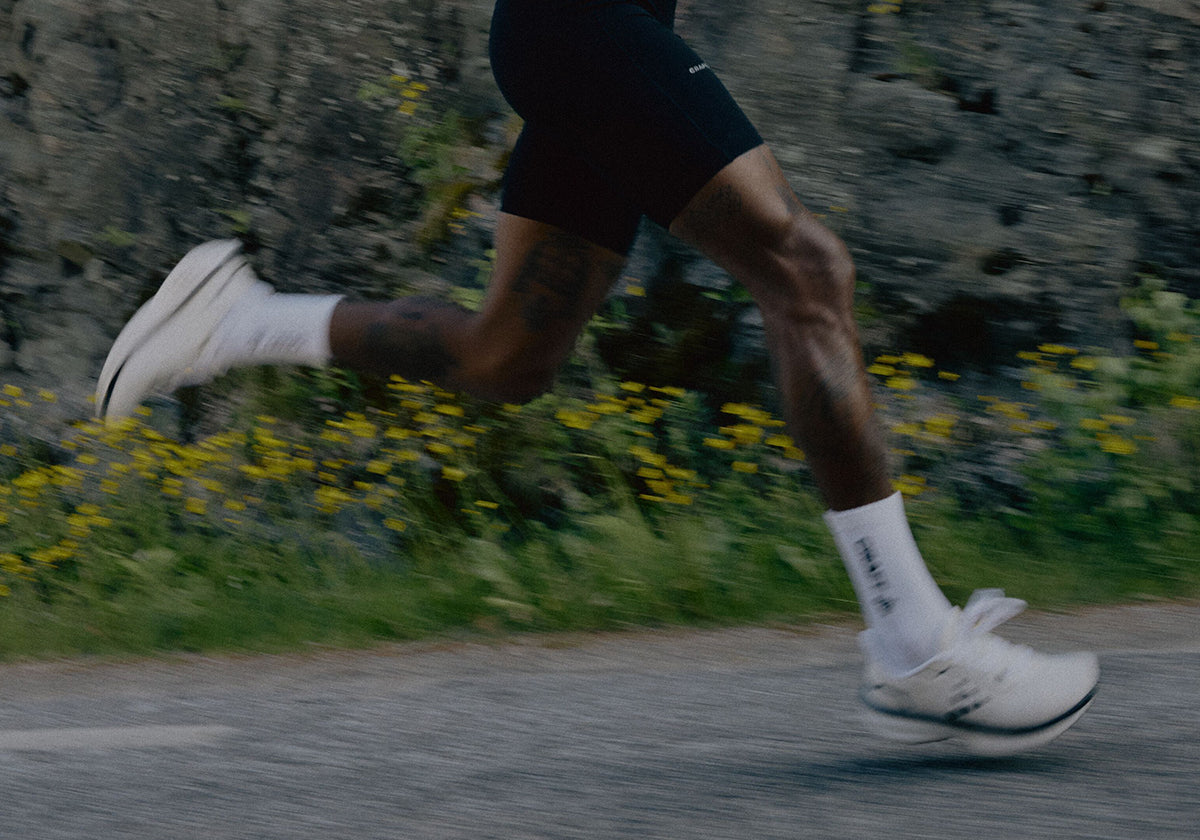 Person running on a road with a natural background