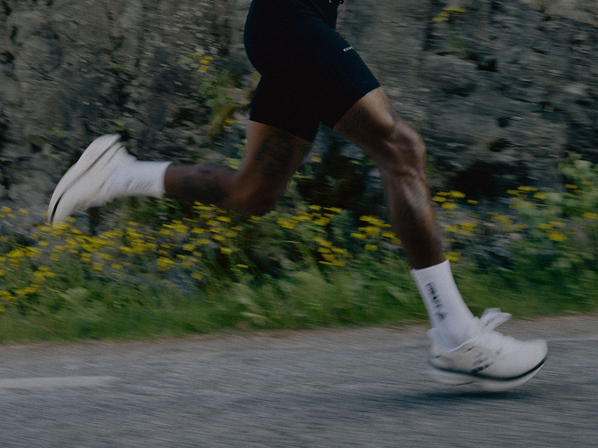 Person running on a road with a natural background