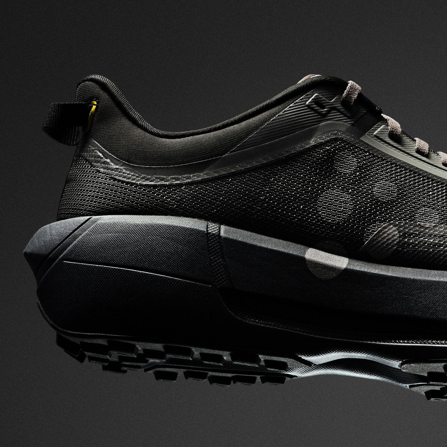 Black athletic shoe on a black background