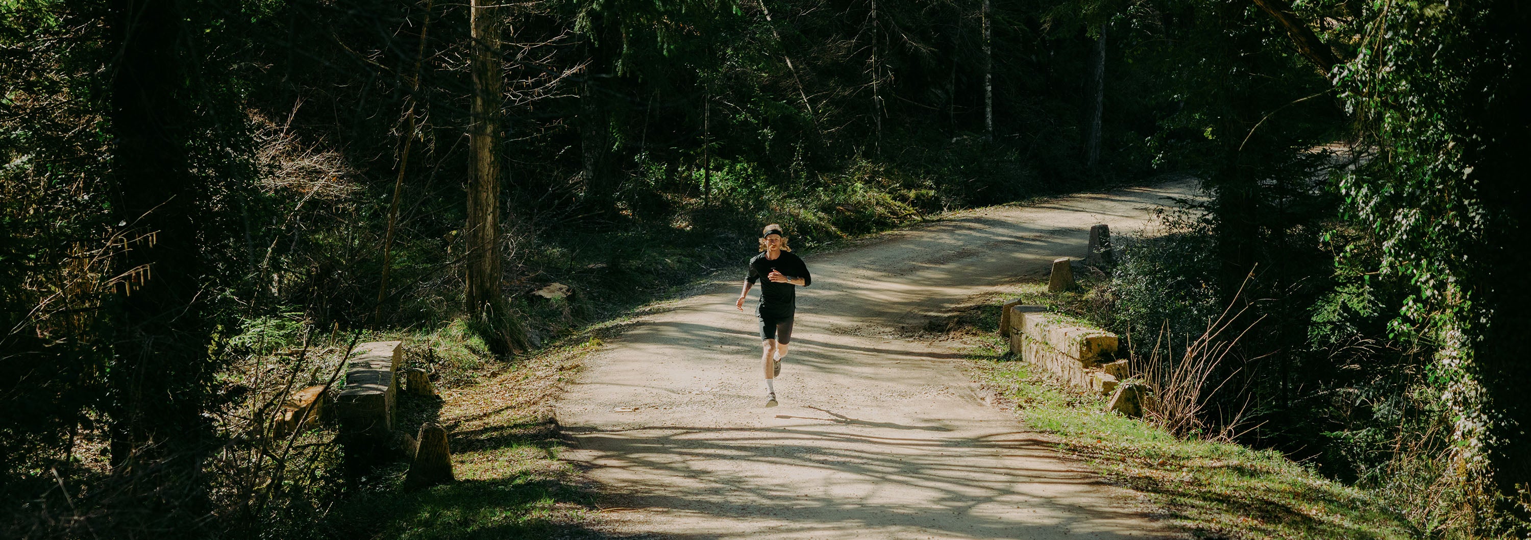 Person running on a path through a forest