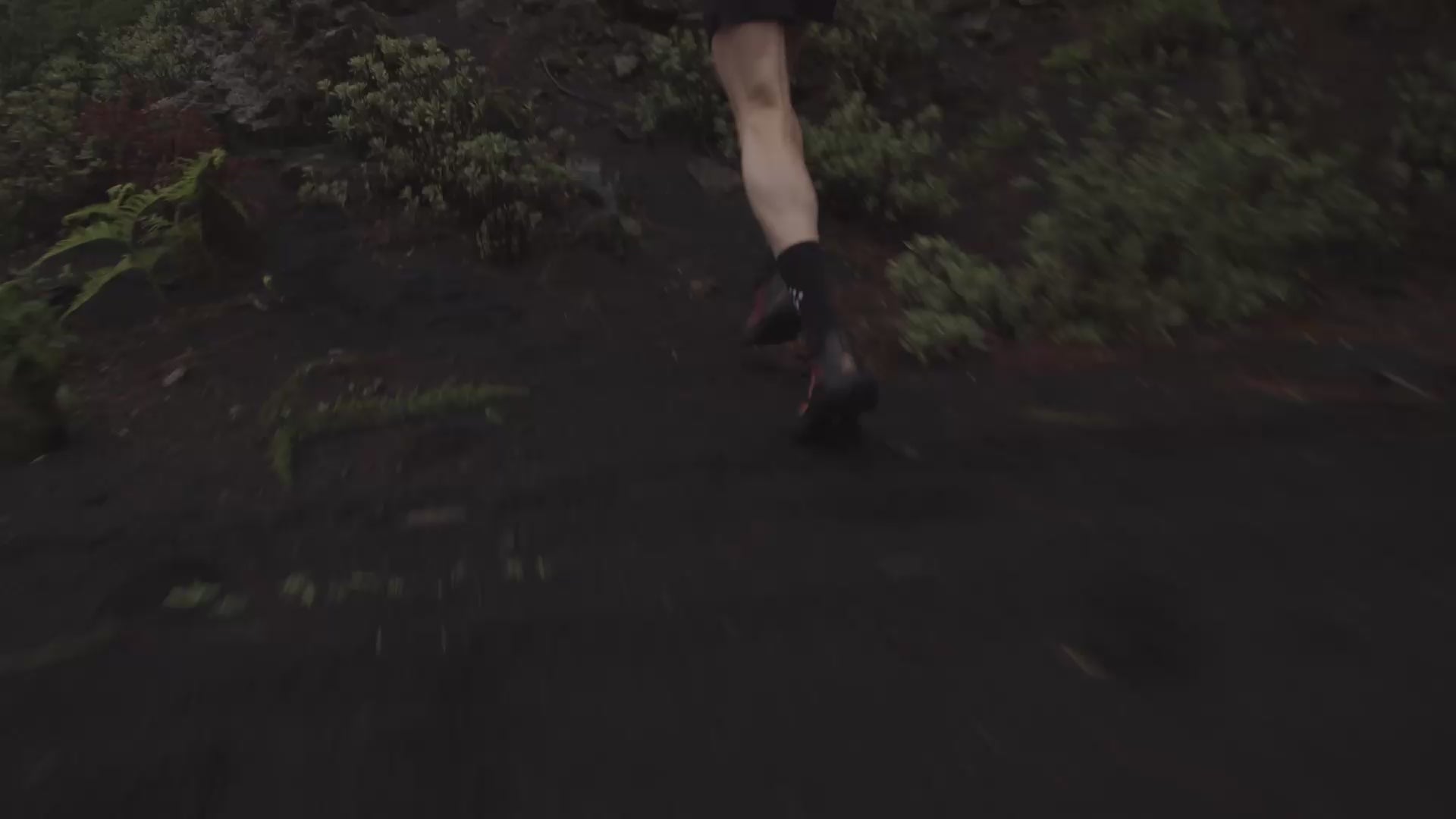 Man running through mountain landscape in the rain